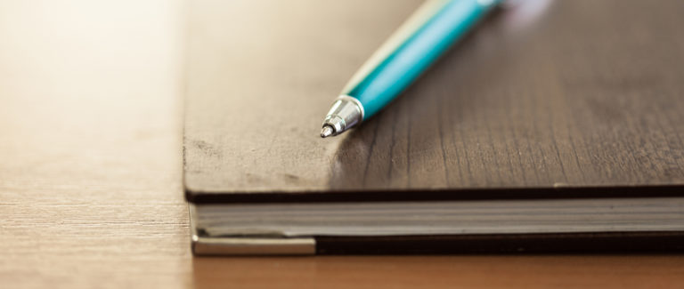 blank-note-paper-with-pen-on-wood-background-2026-03-19-08-17-00-utc - SER